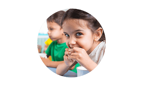 Children eating a healthy snack at table