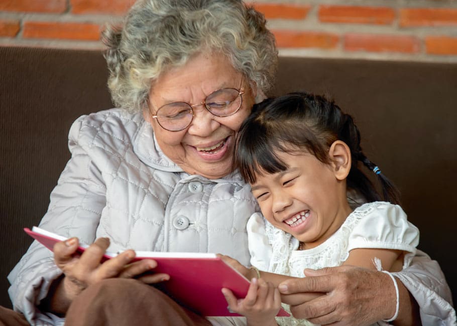 grandmother reading to granddaughter