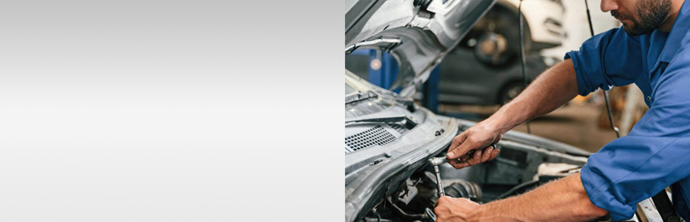 Mechanic working on car engine
