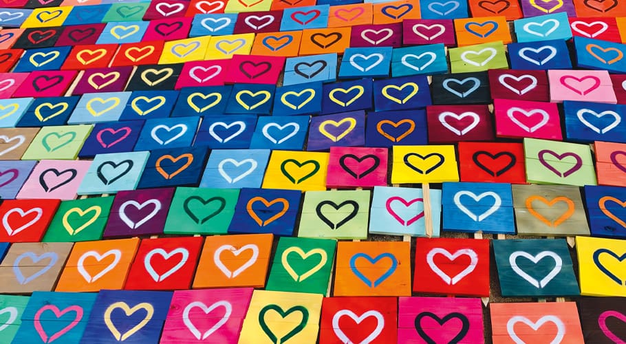 multicolored signs with hearts on them sprawled across the ground, extending beyond the frame of the image