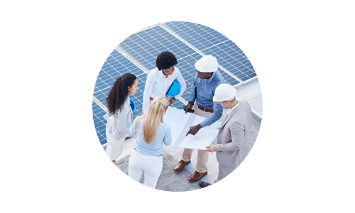 Team of people atop building with solar panels for sustainable clean energy