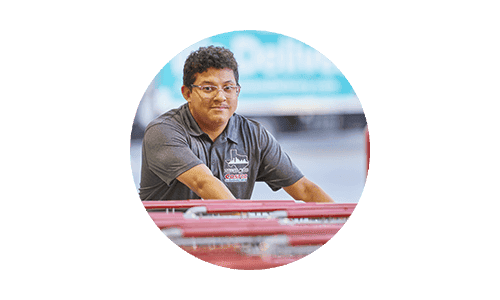 Costco employee pushing carts at Costco warehouse