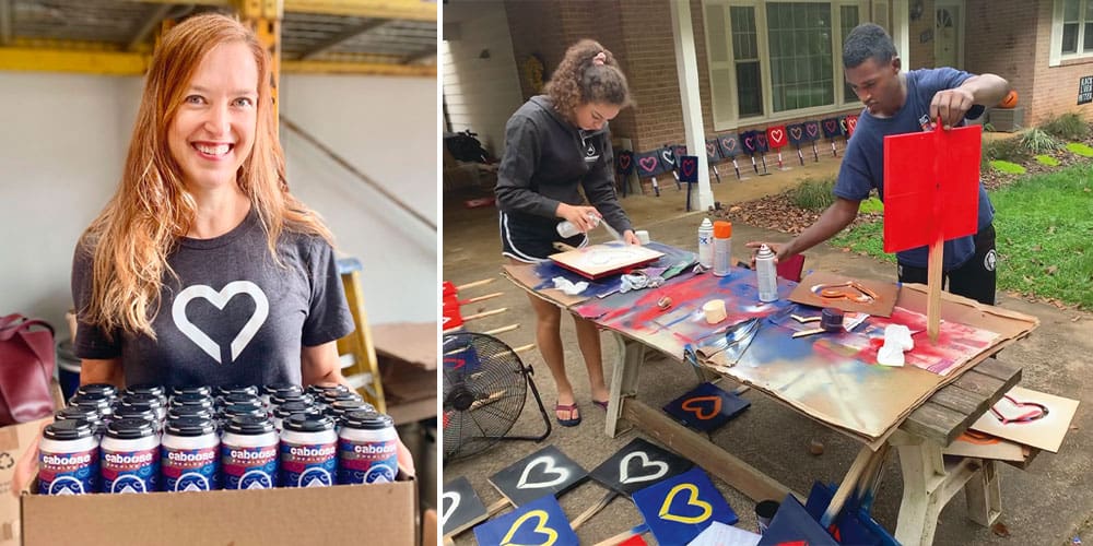 A woman holding a case of drinks wearing a heart t-shirt on the left. On the right two people spray painting signs with the heart logo on them.