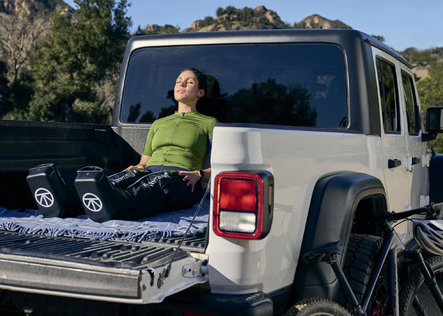 woman sitting in the bed of a pickup