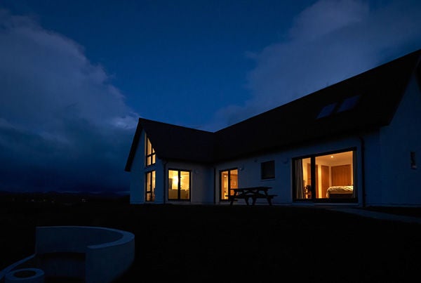 A house in the dark with lights on