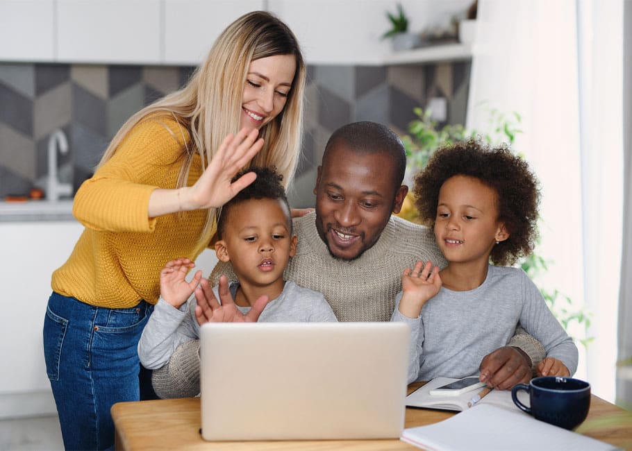 a family in front of a laptop