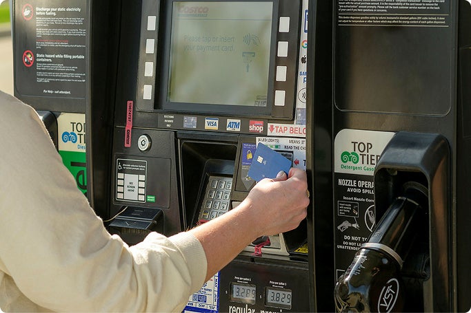 Image of a person at a gas pump using Tap to Pay