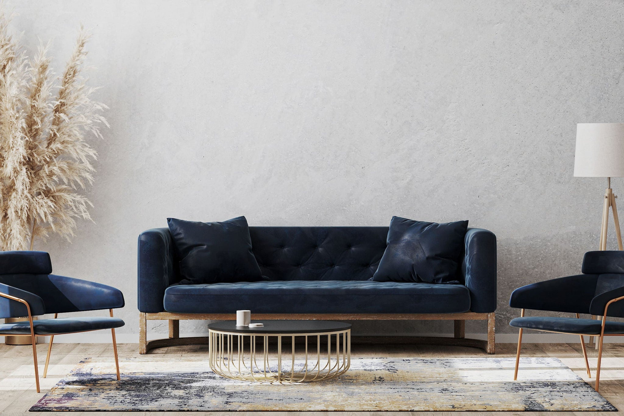 Living room setting with dark blue sofa, two chairs, round coffee table on top of a rug