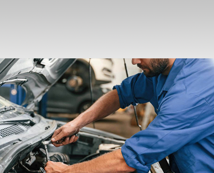 Mechanic working on car engine