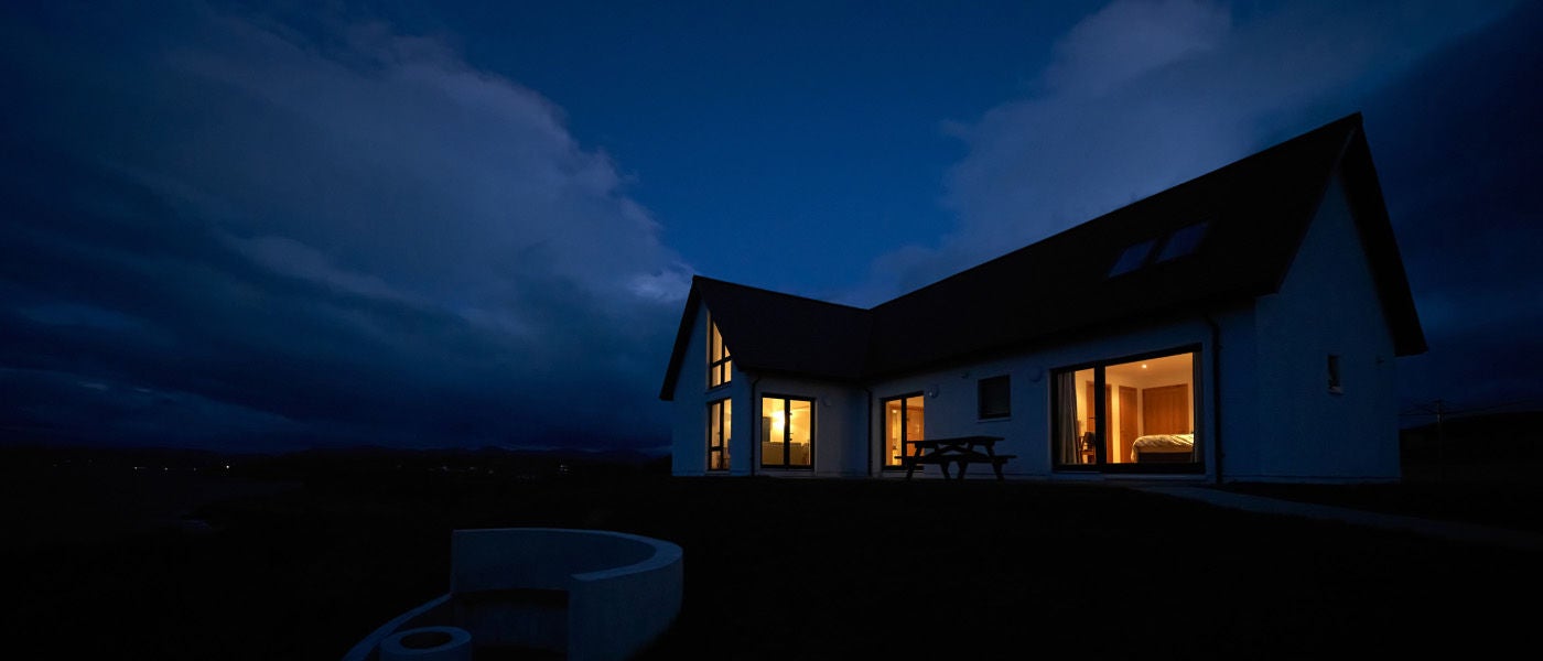A house in the dark with lights on