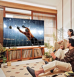 Samsung Crystal UHD TV showing a soccer match while a man and woman cheer.