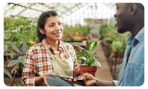 a man and woman in a greenhouse