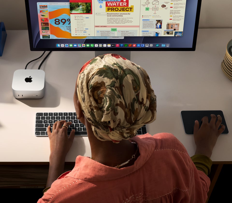 Person using Mac mini to work on their project using wireless keyboard and trackpad