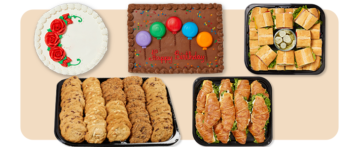 Assorted party catering platters featuring cakes, cookies, sub sandwiches, and croissant sandwiches